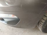 a close up of a car ' s front bumper with a hole in the bumper