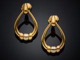 a pair of gold and pearl earrings