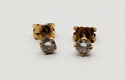 pair of diamond stud earrings on white background