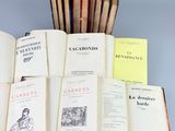 several old books are stacked on top of each other on a table