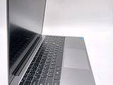a silver laptop computer sitting on top of a white table