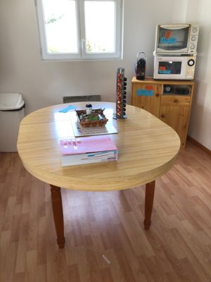 a wooden table with a book on it in a room