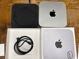 a box with an apple computer and a charger on it