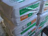 a stack of bags sitting on top of a pallet in a warehouse
