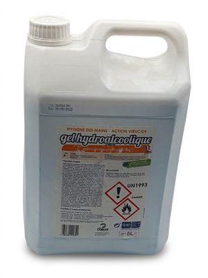a close up of a bottle of liquid on a white surface