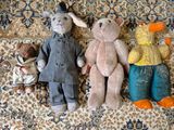 trois peluches assises sur un tapis