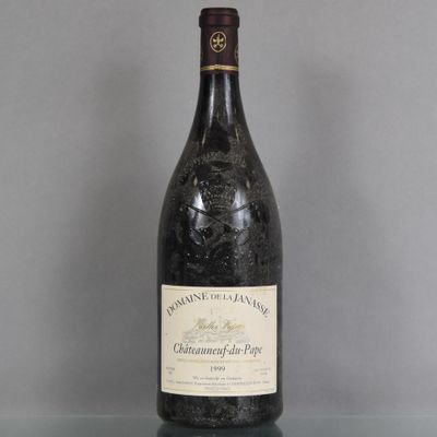 a bottle of wine sitting on a glass table