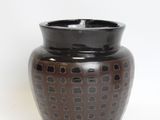 a brown vase with a black lid on a white background
