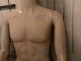 a male mannequin in the corner of a room