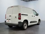 the white van is parked in the empty room of the building