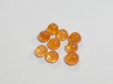 an image of a group of orange pills sitting on top of a white surface