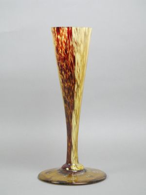 a glass vase with a brown and yellow design on it