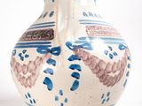 a blue and white vase sitting on a white surface