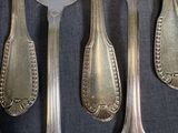 a lot of silver spoons and spoon spoons on a table