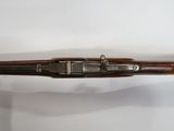 an old gun with a wooden handle on a white surface