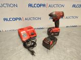 a corded drill and two other tools on a table