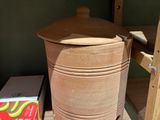 a wooden shelf with a pot and a box on it