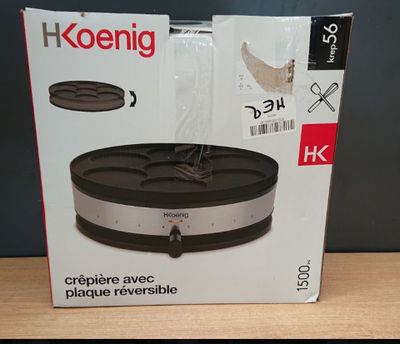 packaging of a black and silver food warmer on a wooden table