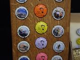a bottle cap display with a lot of different pictures on it