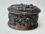 a silver box with a design on it on a white surface