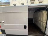 a white van with its door open in the street