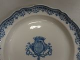 a blue and white plate with a crown on it