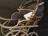 a baby carriage with a baby in it on a black background