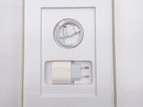 a white box with a charger and a cable in it