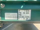 a green truck with a license plate on the back of it