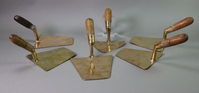 four pieces of metal and wood are arranged in a circle