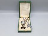 a silver spoon and fork in a green box
