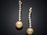a pair of pearl and diamond earrings