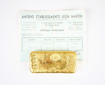 a gold bar sitting on top of a piece of paper