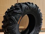 a tire that is sitting on the floor in front of a cardboard box