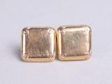 pair of gold tone square earrings on white background