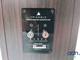 a close up of a speaker on a wooden wall