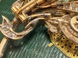 a close up of a brooch on a green cloth