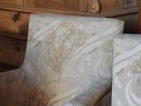 a chair that has a pillow on it and a chair that has a pillow on it