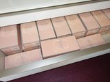 a drawer full of boxes of makeup on the floor