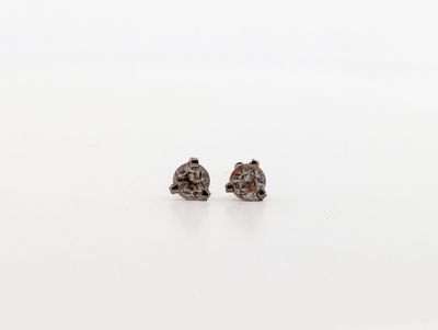 a pair of brown diamond stud earrings on a white surface