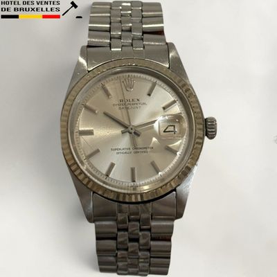 an image of a wrist watch with a silver dial on a white background