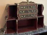 a red and gold desk with a marble top