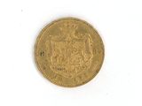 a close up of a gold coin on a white surface