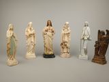 several statues of jesus and other religious figures on a gray background