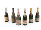 a group of six bottles of champagne sitting next to each other