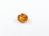 an orange diamond on a white surface with a white background