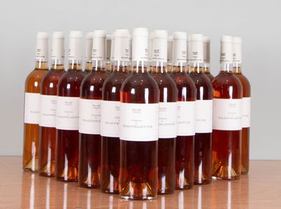 six bottles of wine are lined up on a wooden table