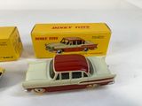 two toy cars sitting next to each other on a table
