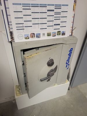 a safe box with a poster on it in the corner of a room