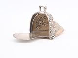silver plated spoon and spoon rest on a white surface